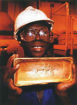 A miner with a gold bar