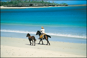 Horse riding along the blue waters in Natadola